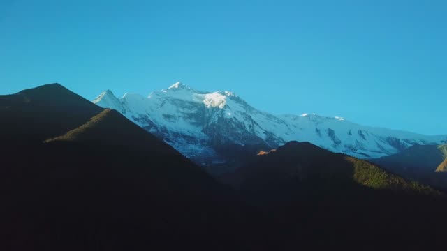 Sunrise-above-peak-in-the-Himalaya-range,-Nepal