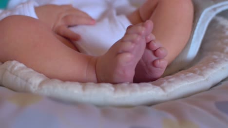 Close-up-of-a-newborn-baby's-toes-as-she-sits-in-a-bouncer