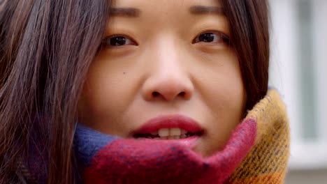 close-up-portrait-of-pretty-asian-woman-smiling-at-camera-outdoor