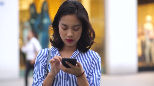 young-woman-using-phone-in-city,4k