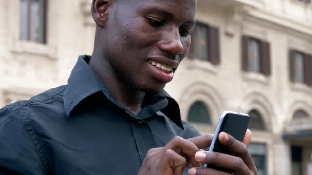 Modernität,-Technik,-Jugend.-Junge-schwarze-Afrikaner,-die-Eingabe-auf-Smartphone-outdoor