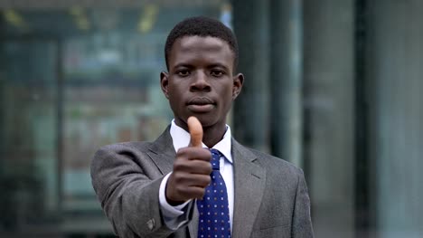 Young-African-American-businessman-making-thumb-up.-Positivity,optimism--outdoor