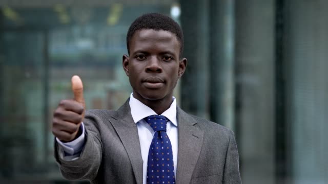 Young-black-africam-man-making-making-thumbs-up.-Success,winning