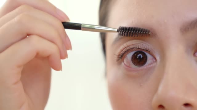 female-applying-brow-gel-for-eyebrows.
