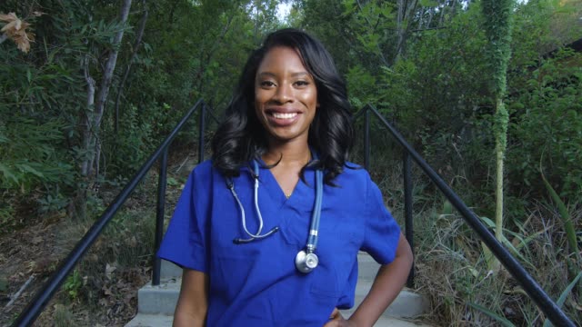 Beautiful-African-American-woman-in-scrubs-smiling-at-the-camera