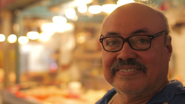 Portrait-of-a-hispanic-butcher-smiling-at-the-camera