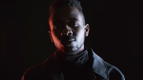 Portrait-Shot-of-Black-Man-in-Dark-Studio