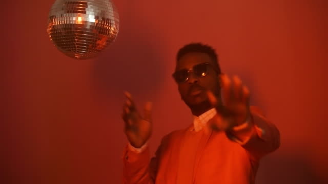 Black-Man-Spinning-Disco-Ball-and-Partying