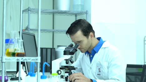 Portraits-of-scientist-male-is-looking-through-microscope-and-working-in-modern-laboratory-or-medical-center.-Concept-of-science,-testing-development-and-lab-industry.