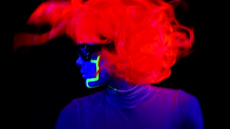 Woman-with-UV-cyborg-face-paint,-wig,-glowing-clothing-portrait-dancing-hard.-Asian-woman.-.
