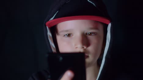 4k-Face-Portrait-of-Boy-Child-Posing-with-Mobile-Phone