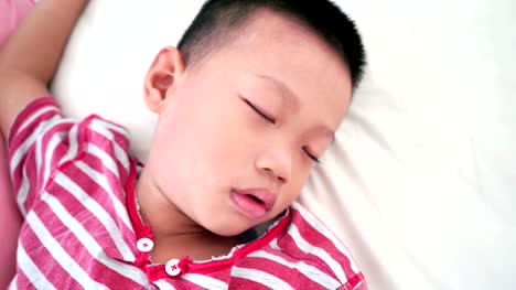 Boy-sleeping-on-bed