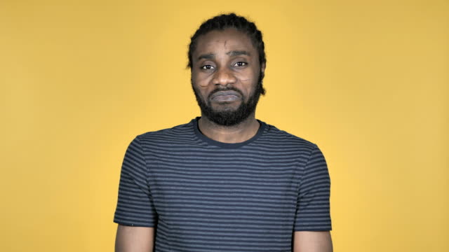 Yes,-Casual-African-Man-Shaking-Head-to-Accept-Isolated-on-Yellow-Background