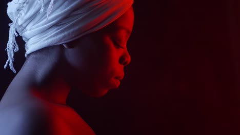 Serene-Black-Woman-in-Turban-Looking-at-Camera