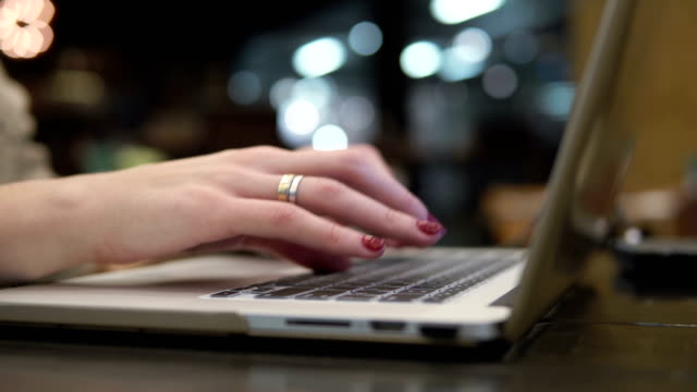 Closeup-hands.-Businesswoman-working-on-laptop-in-modern-cafe-4k