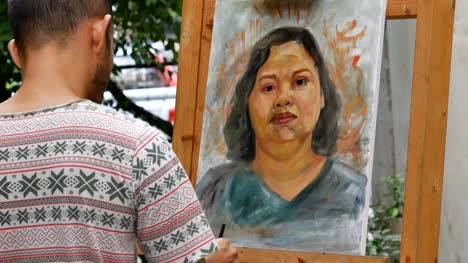 Artist-painting-portrait-of-asian-woman