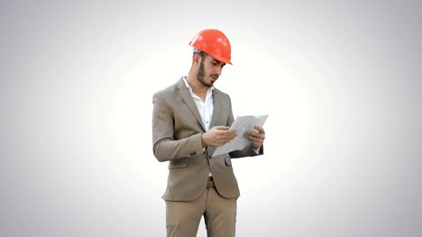 Architect-in-helmet-checking-construction-plan-on-white-background
