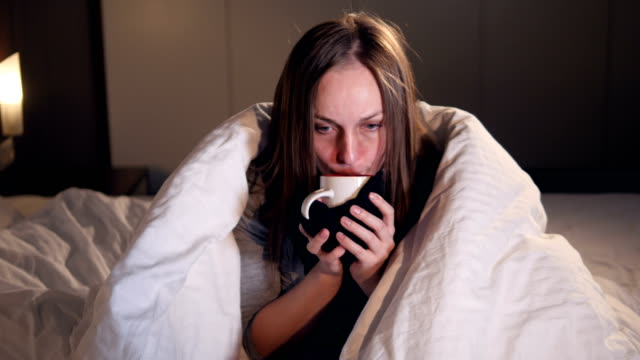 The-portrait-of-the-ill-woman-drinking-the-hot-tea.-Close-up.-4K.