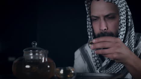 Hombre-árabe-beber-té-de-4-k