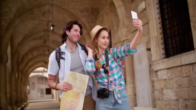 Young-tourists-taking-a-selfie-in-a-picturesque-medieval-town