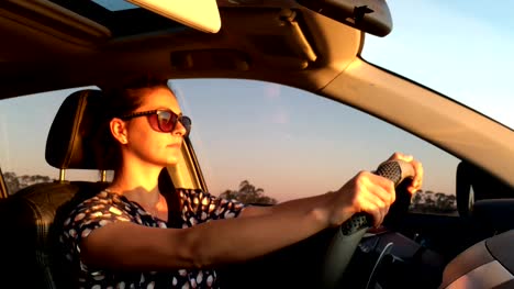 Drive.-Goal-oriented-woman-in-her-30's-driving-during-golden-hour