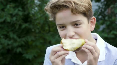 Cute-teenager-eats-a-pear