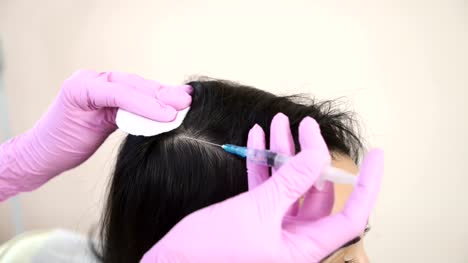 Needle-mesotherapy.-Cosmetic-been-injected-in-woman's-head.-Thrust-to-strengthen-hair-and-their-growth