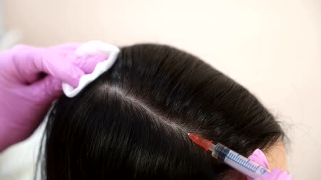 Handsome-woman-receives-an-injection-in-the-head.-The-concept-of-mesotherapy.-Thrust-to-strengthen-the-hair-and-their-growth