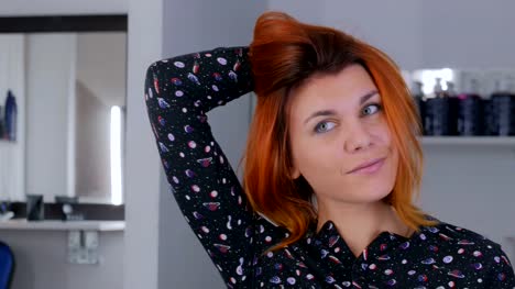 Pretty-young-woman-with-orange-hair-color-at-hairdressing-salon
