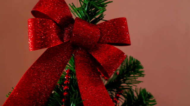 Mans-hand-decorating-christmas-tree