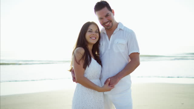 Portrait-of-beautiful-Latin-American-couple-on-beach