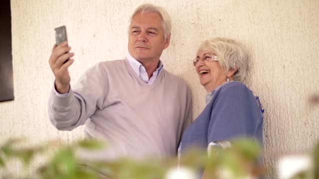 Active-senior-couple-taking-selfie
