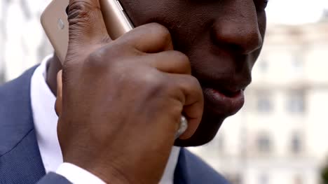 close-up-on-black-businessman-talking-on-the-phone