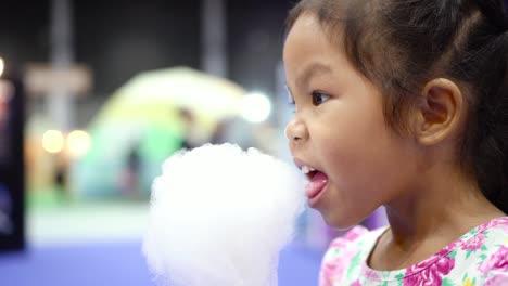 Little-Girl-Eating-a-Cotton-Candy