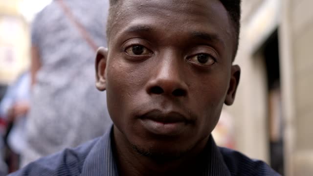 close-up-portrait-of-sad-desperate-young-black-man-raising-his-head-and-staring-at-camera