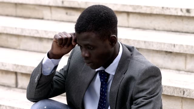 Thoughtful-worried-young-black-african-business-man-alone-in-the-city
