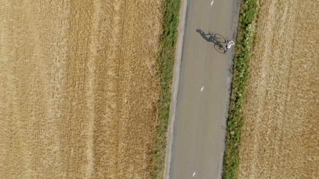 Drone-shot-of-man-practicing-bicycle.-Aerial-view-of-athlete-training-for-a-triatlon-race,