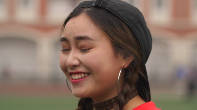 Side-view-of-Asian-college-girl-smile-4k