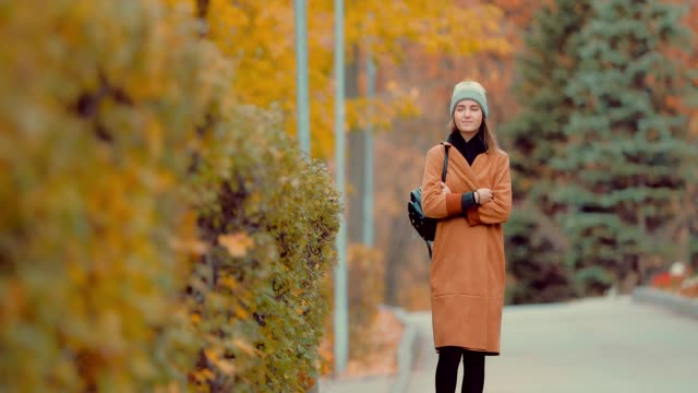 Young-girl-walking-in-autumn-park
