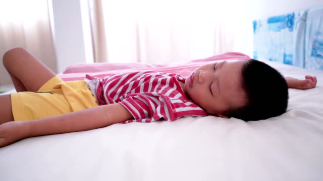 Boy-sleeping-on-bed