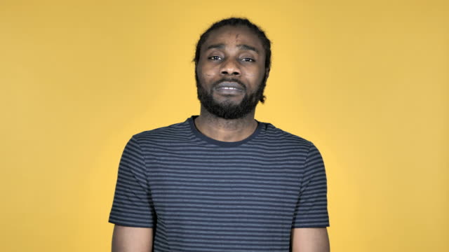 Sad-Upset-Casual-African-Man-Isolated-on-Yellow-Background
