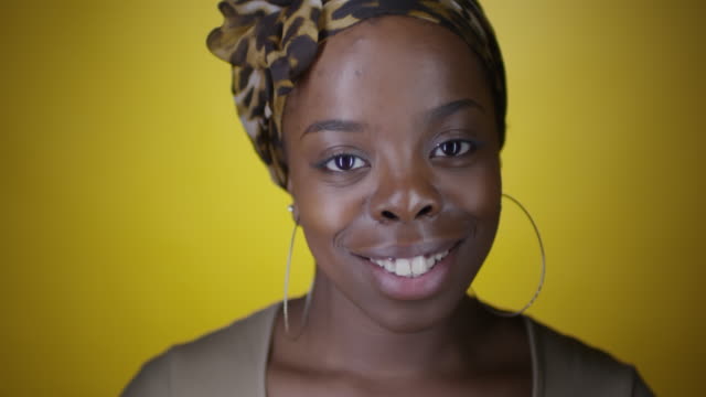 Joyous-Black-Woman-Smiling-on-Yellow-Background