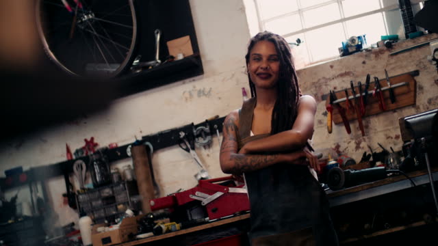 Afro-craftswoman-standing-in-her-workshop-with-her-tools