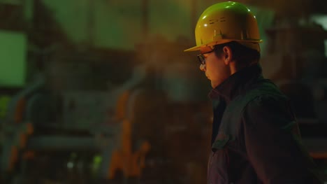 Portrait-of-Heavy-Industry-Technician-Putting-on-Hard-Hat.-Rough-Industrial-Environment.