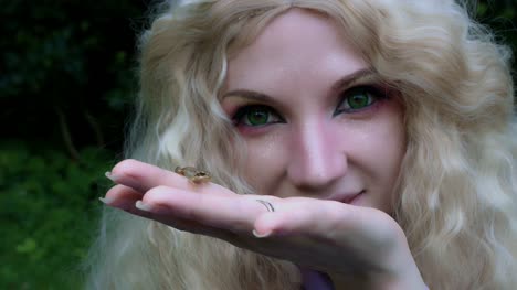 4k-Fantasy-Shot-of-a-Fairy-Holding-a-Tiny-Frog-in-hands