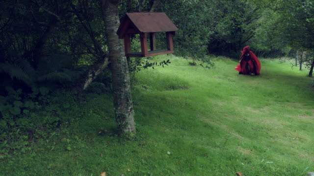 4k-Halloween-Shot-of-Red-Riding-Hood-Running-in-Forest-Scared