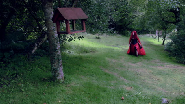 4k-Halloween-Shot-of-Red-Riding-Hood-Walking-in-the-Forest