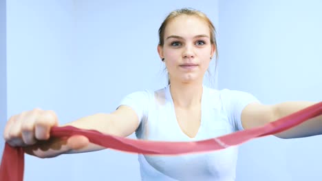 A-girl-is-training-her-hands-with-a-rubber-bandage
