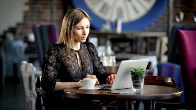 Beautiful-girl-with-laptop.-Young-attractive-female-sitting-at-cafe-and-using-laptop