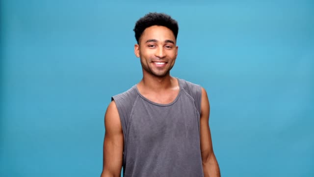 Young-happy-african-man-showing-okay-gesture-over-blue-background.
